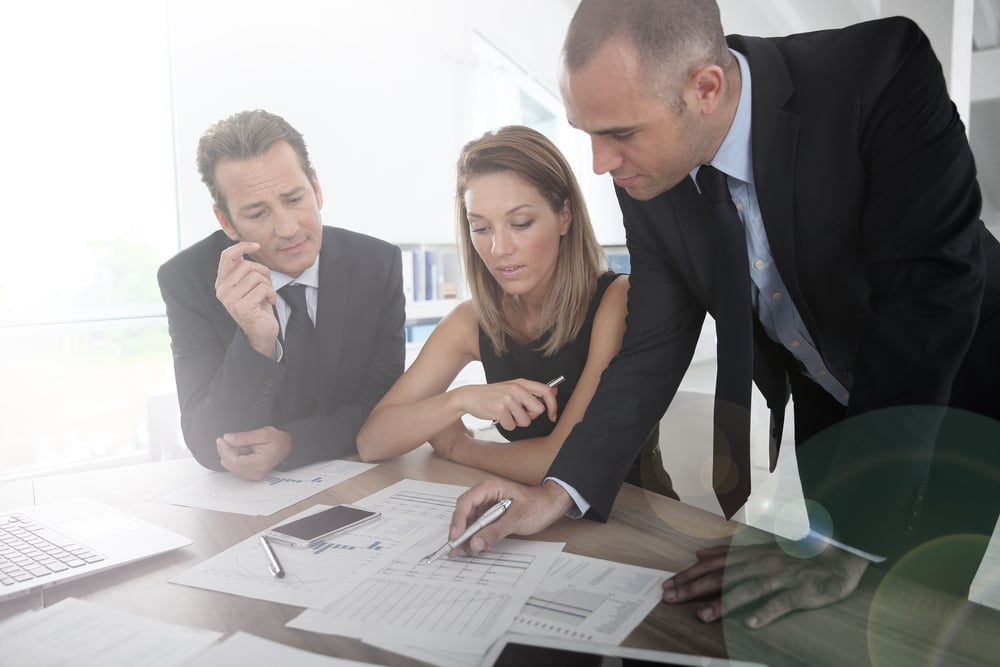 Business people looking at budget forecast for account management software