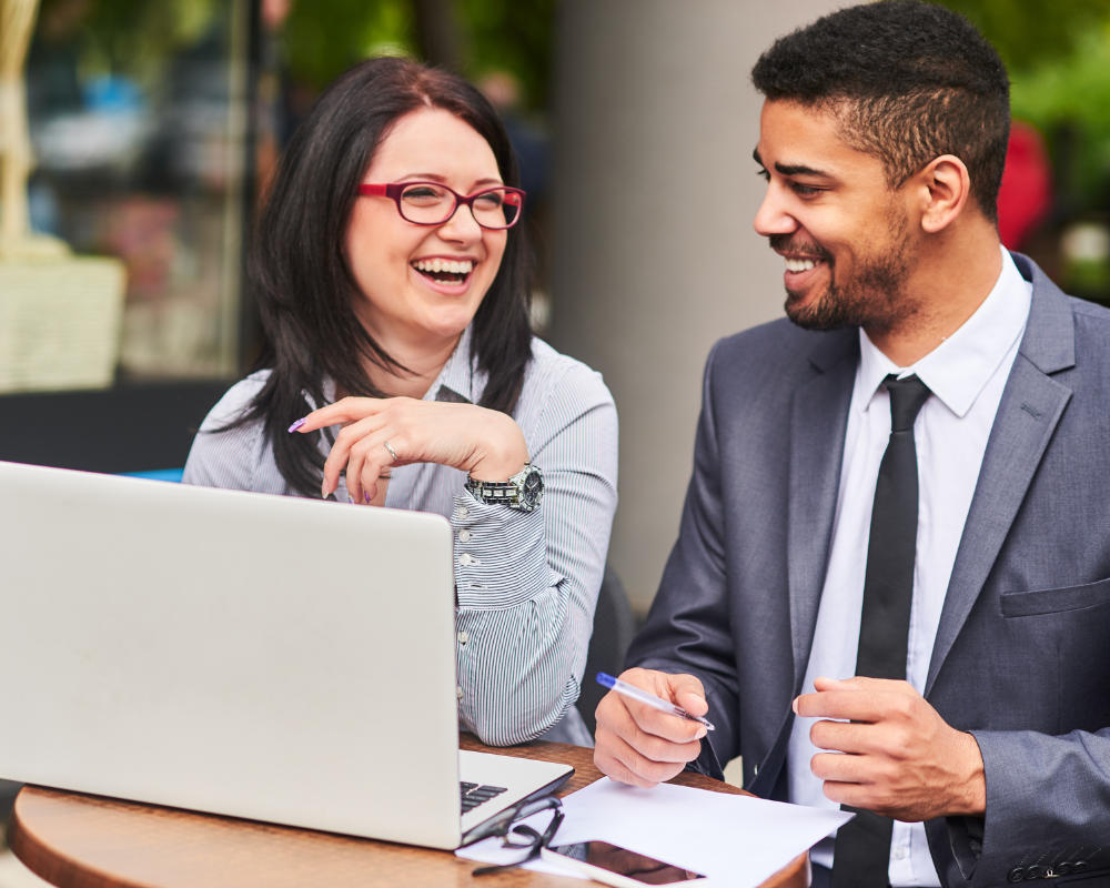 Happy insurance company staff discussing accounting software