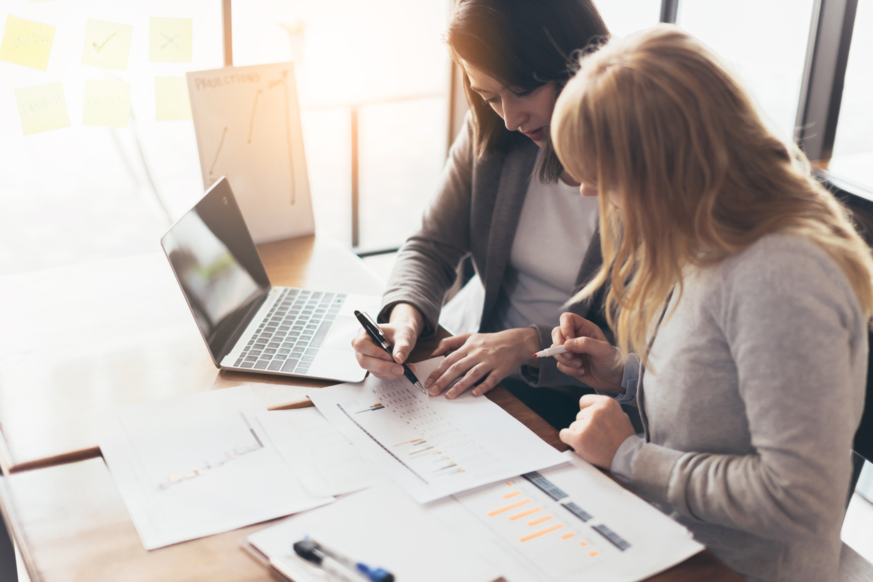 Business working women with laptop and paperwork