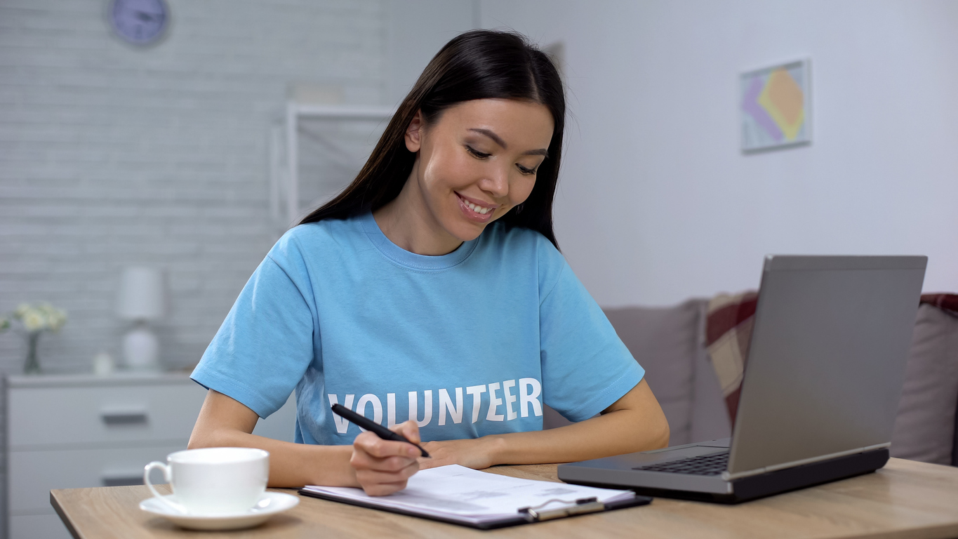 A charity workers using iplicits grant reporting software to produce accurate reports on grant budget and spending