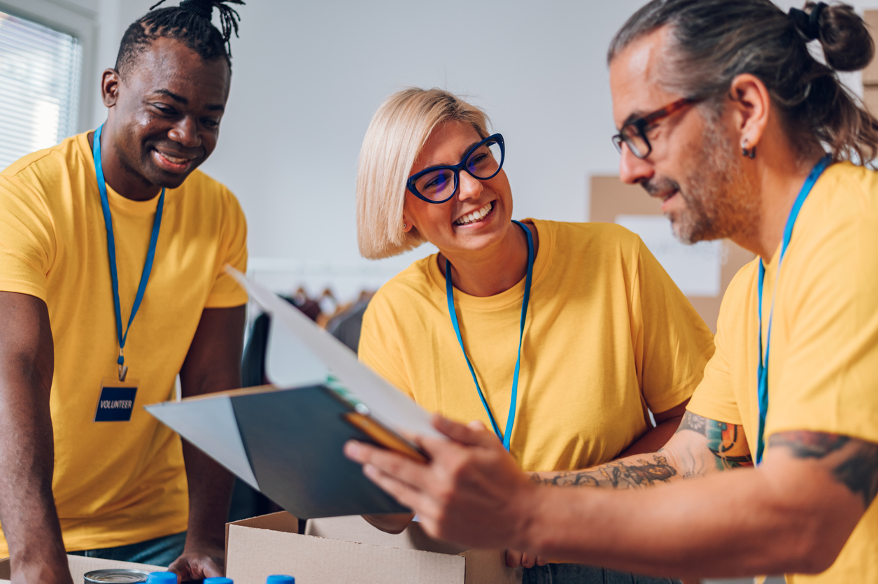 A group of charity workers using iplicit's grant financial management software to track how grant funding has been spent.