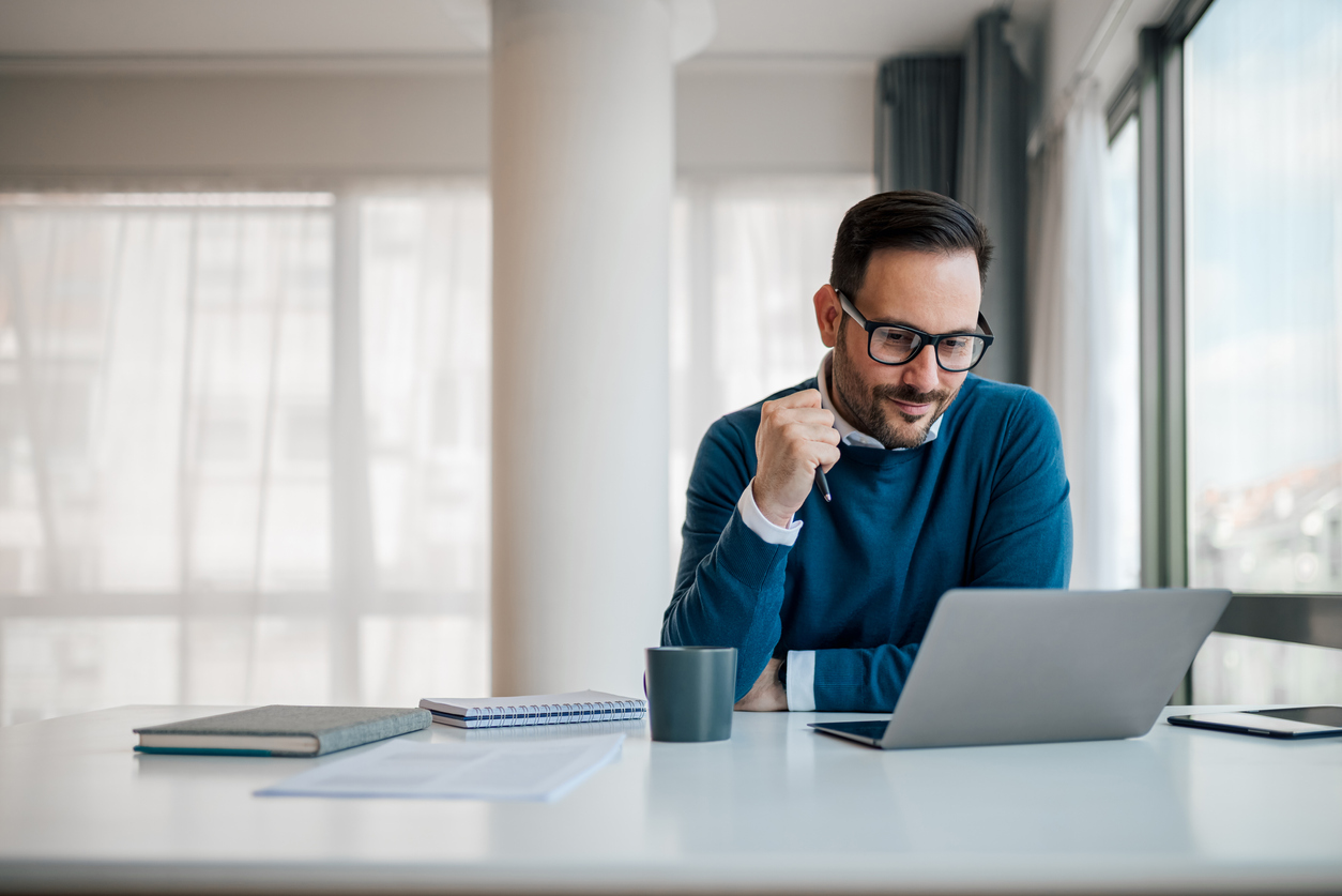 Male professional is planning strategy while sitting at office desk