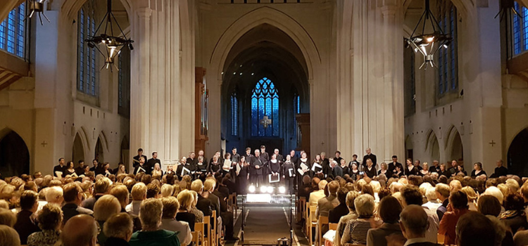 A choir singing in a church to a crowd of people